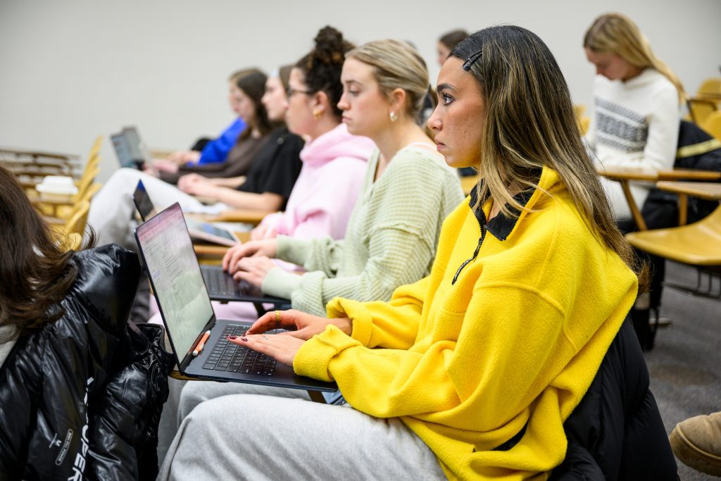 students taking notes on laptops