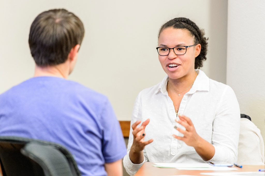 woman talking to a man using expressive hand movement