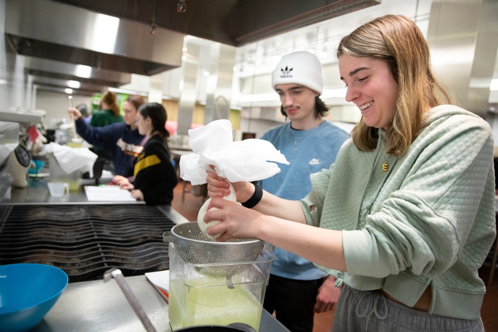 Two students make cheese in a food science laboratory class