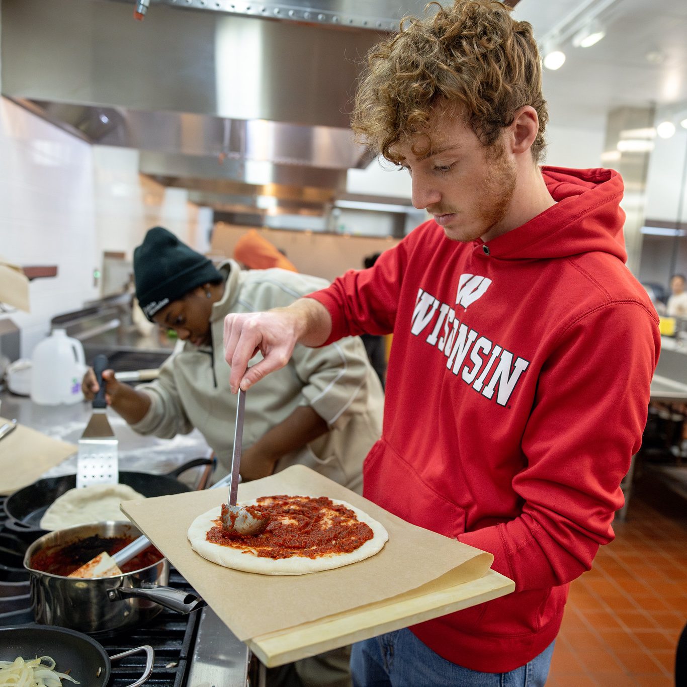 Two students make pizza in the Food Application Lab